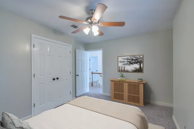 a bedroom with a large bed and a chandelier