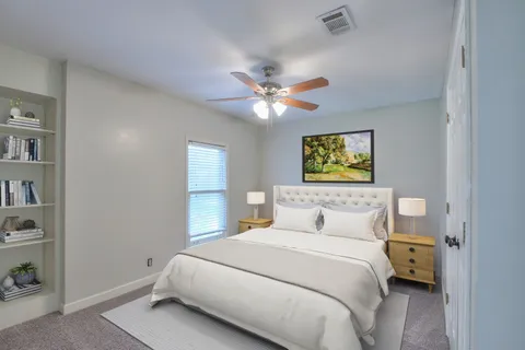 a bedroom with a bed and a chandelier