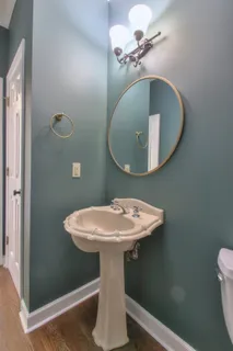 a bathroom with a sink a mirror and toilet