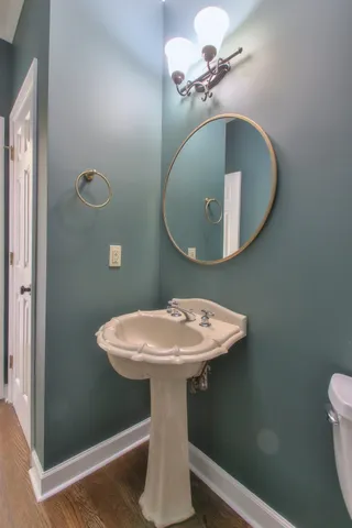 a bathroom with a sink a mirror and toilet