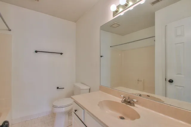 a bathroom with a sink toilet and vanity