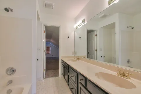 a bath room with a sink and a mirror