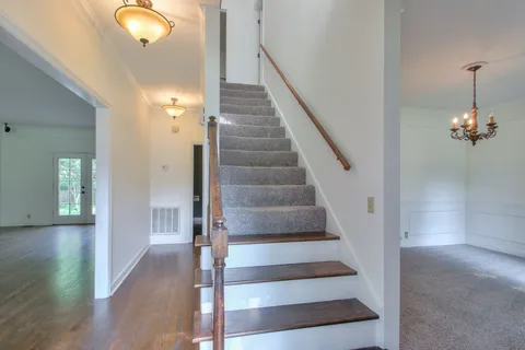 a view of entryway and hall with wooden floor