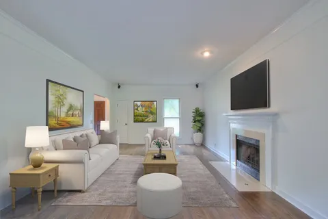a living room with furniture a fireplace and a flat screen tv