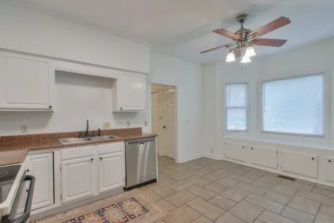 a kitchen with a sink cabinets and window