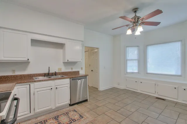 a kitchen with a sink cabinets and window