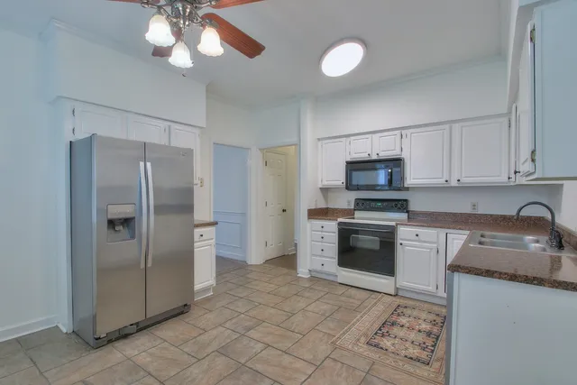 a kitchen with stainless steel appliances granite countertop a refrigerator oven a sink and dishwasher