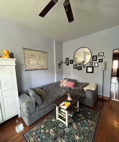 a living room with furniture and flowers