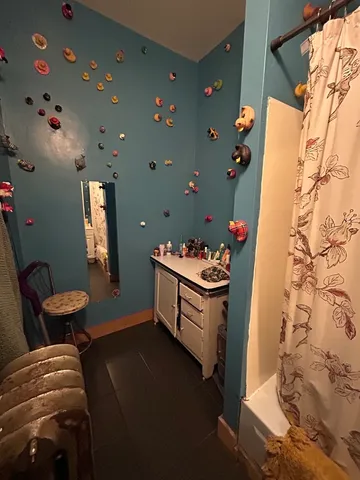 a bathroom with a bathtub sink mirror vanity and toilet