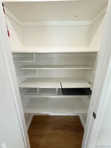 a view of walk in closet with empty racks
