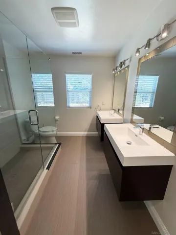 a bathroom with a sink a toilet and mirror