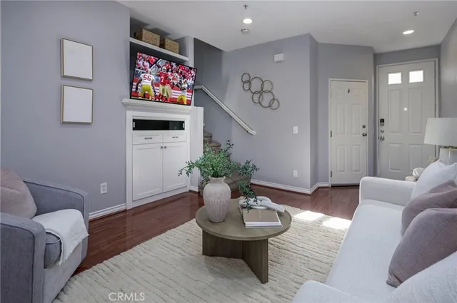 a living room with furniture and a potted plant
