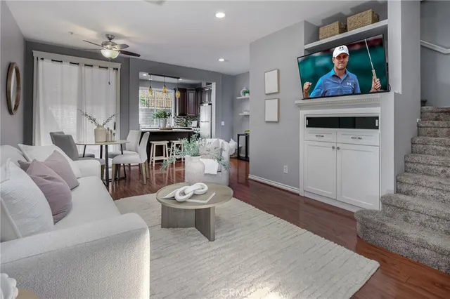 a living room with furniture a rug and a painting