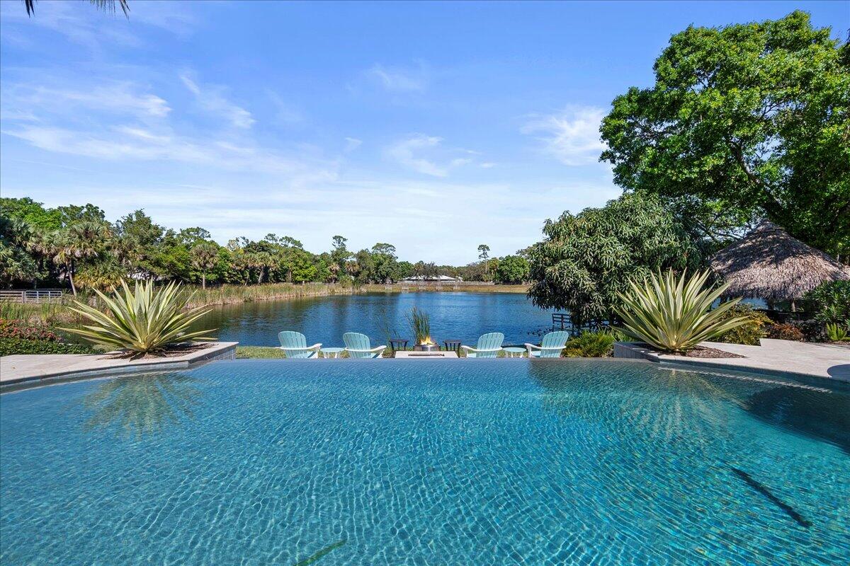 10975 Randolph Siding Road Jupiter, FL 33478 - Photo 55 of 97 a view of a lake with houses in the back