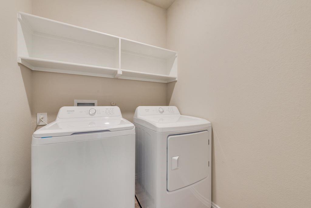 15944 Stableford Road Justin, TX 76247 - Photo 10 of 22 Dedicated utility space featuring overhead open shelving for storage