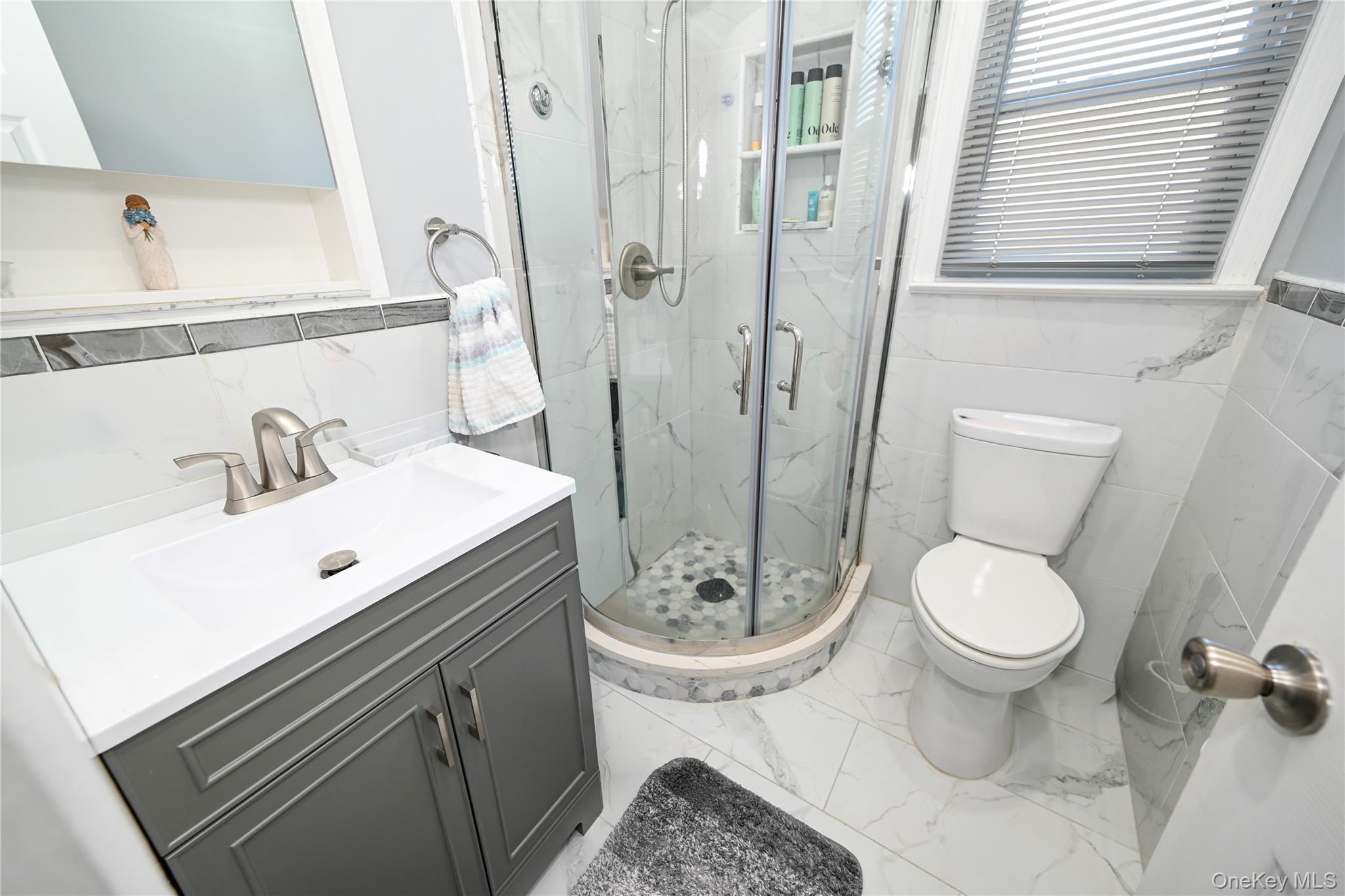 1522 Rica Place Valley Stream, NY 11580 - Photo 11 of 34 a bathroom with a sink toilet and shower