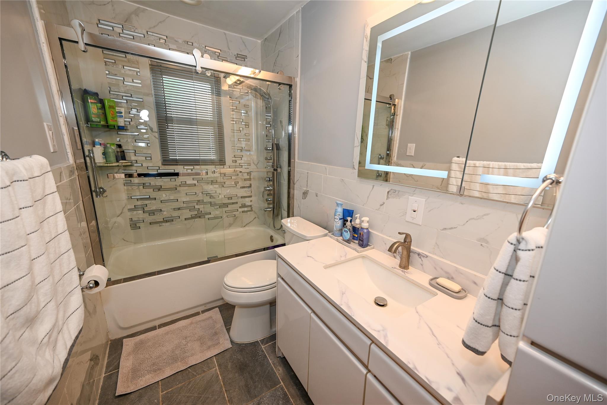 1522 Rica Place Valley Stream, NY 11580 - Photo 12 of 34 a bathroom with a sink toilet and shower