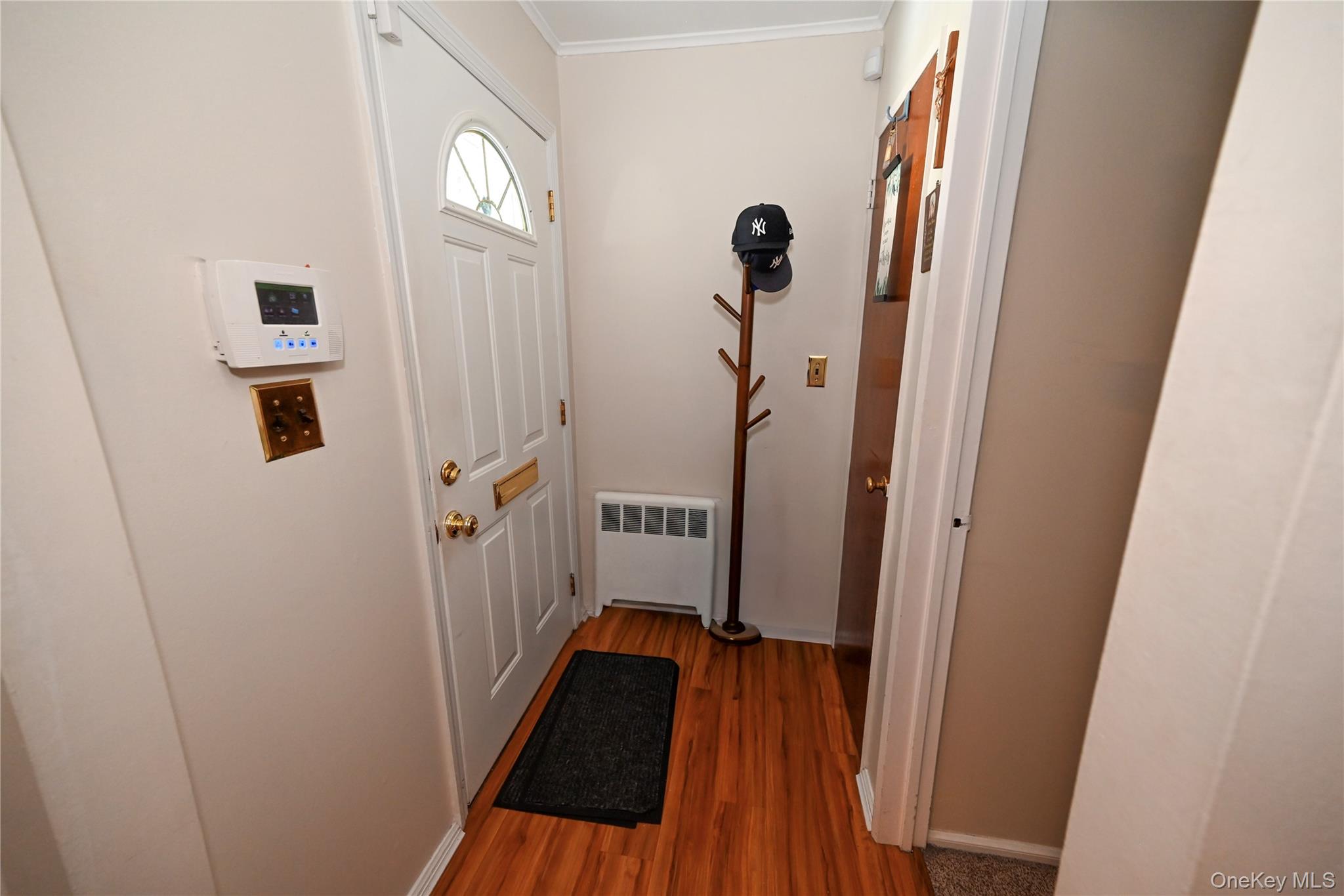 1522 Rica Place Valley Stream, NY 11580 - Photo 2 of 34 a view of a hallway with wooden floor and stairs