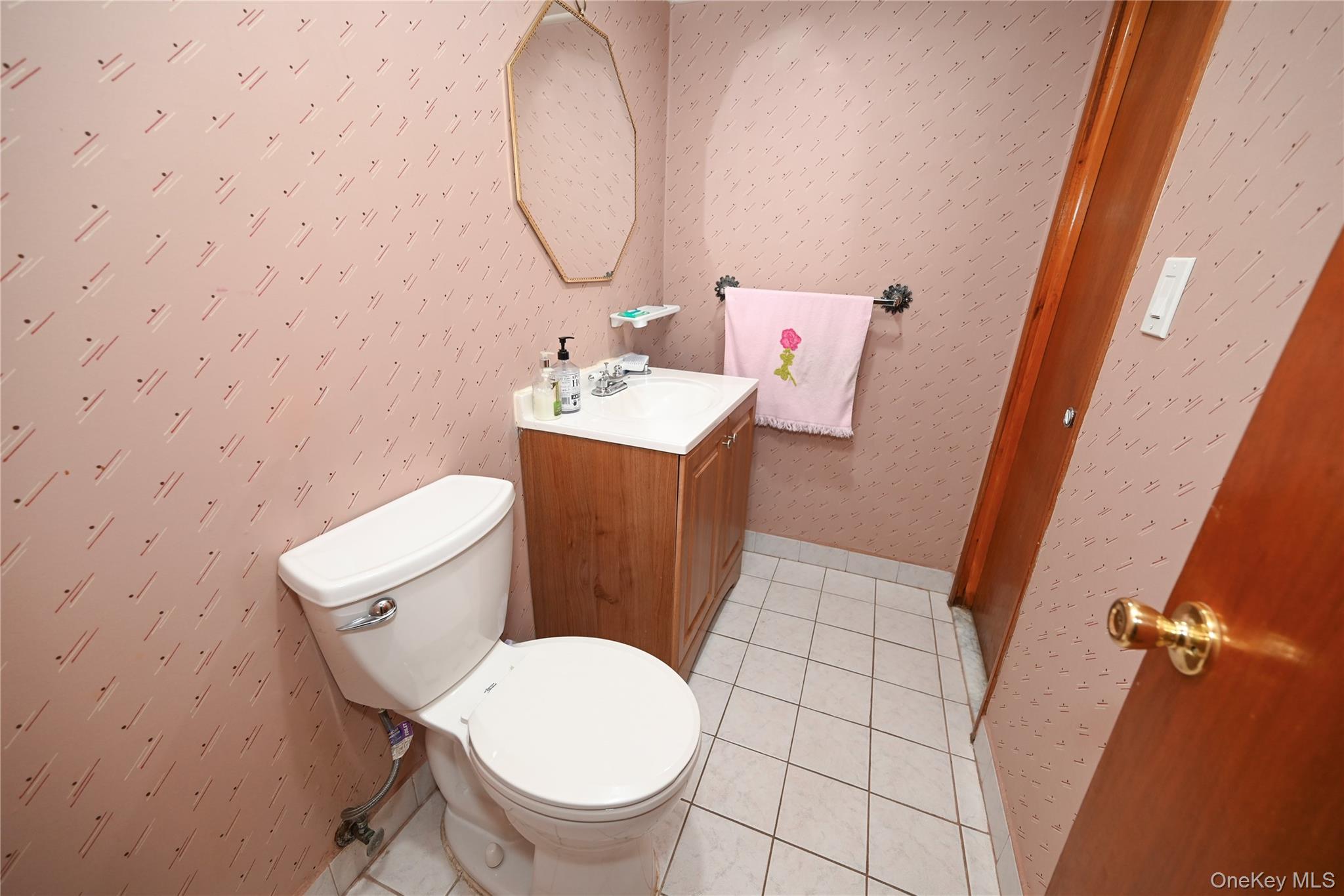 1522 Rica Place Valley Stream, NY 11580 - Photo 21 of 34 a bathroom with a toilet sink and mirror