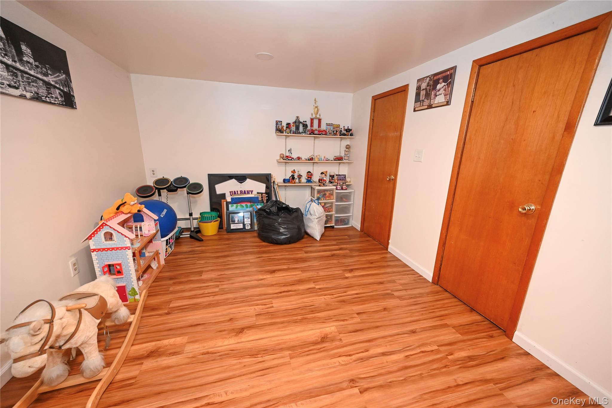1522 Rica Place Valley Stream, NY 11580 - Photo 22 of 34 a view of a room with toys and wooden floor