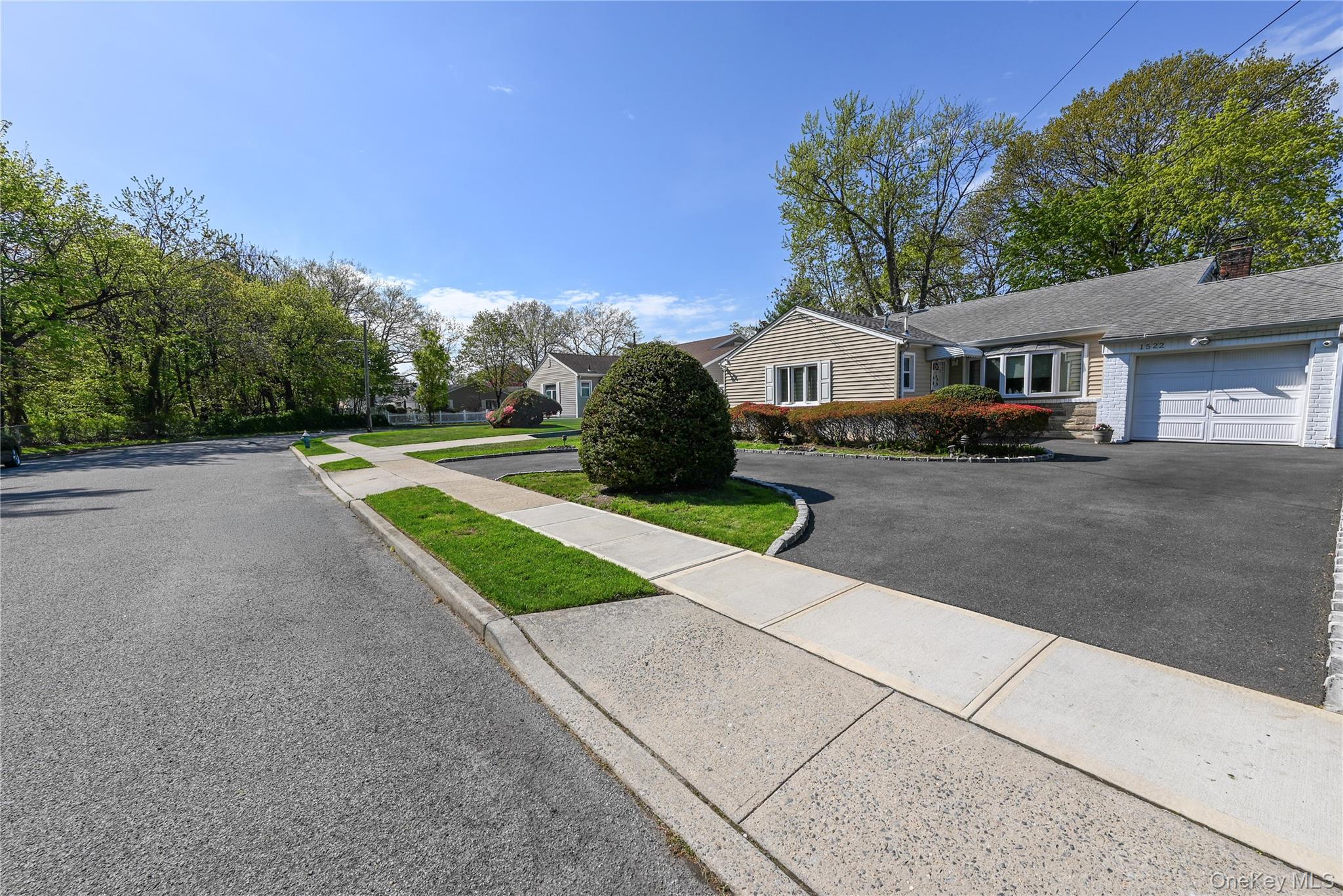 1522 Rica Place Valley Stream, NY 11580 - Photo 31 of 34 a front view of a house with a yard and garage