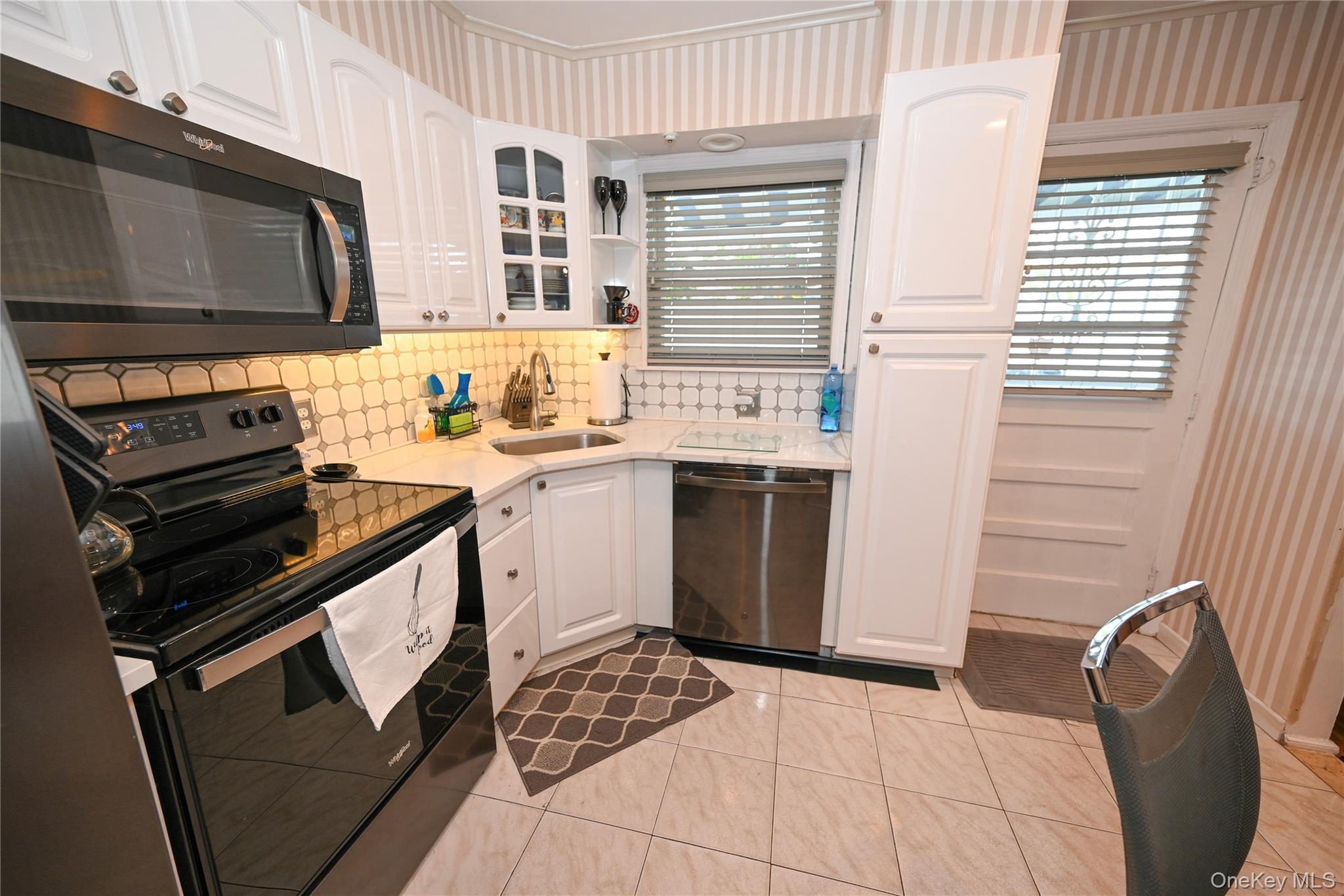 1522 Rica Place Valley Stream, NY 11580 - Photo 7 of 34 a kitchen with a stove a sink and a microwave