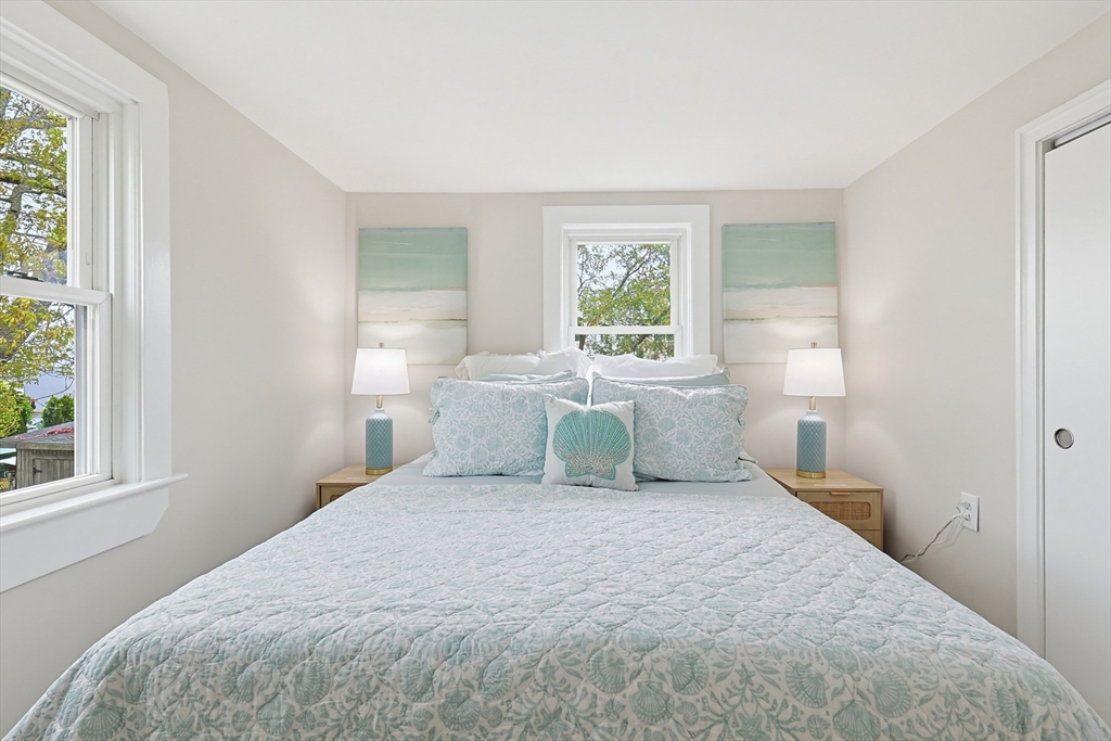 24 Otis Road Barnstable, MA 02601 - Photo 27 of 33 a bedroom with a large bed and a window