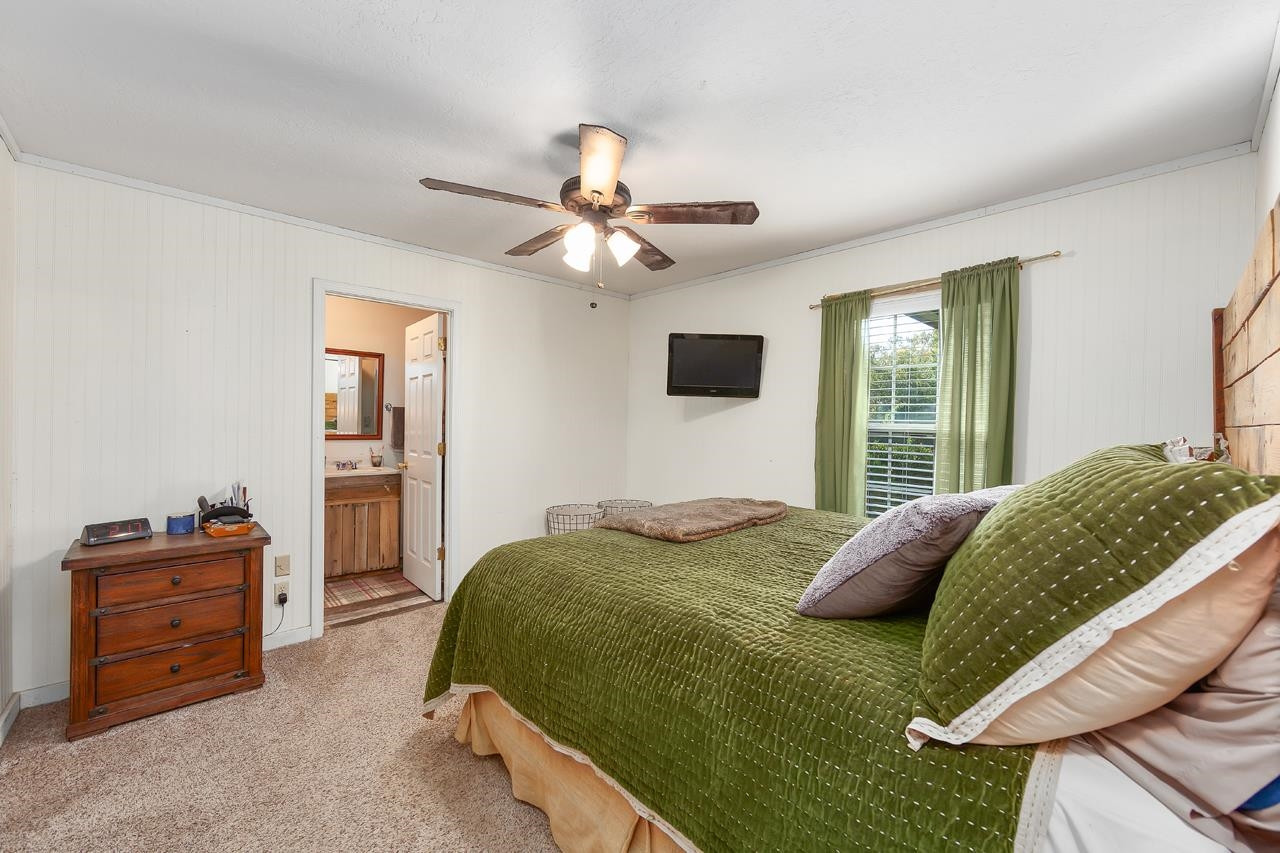179 Poplar Corner Road Bells, TN 38006 - Photo 12 of 24 a bedroom with a bed and a chandelier