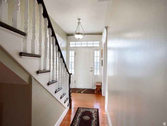155 West Center Street Fillmore, UT 84631 - Photo 41 of 86 Entryway featuring wood-finish flooring, a white paneled front door with sidelights and transom windows, and a staircase with white balusters and dark wood handrails