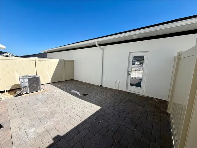 a view of a big room with wooden floor and windows