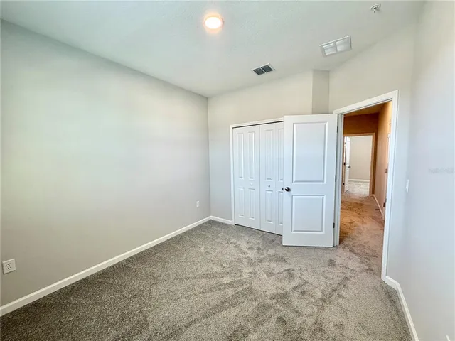 an empty room with closet area