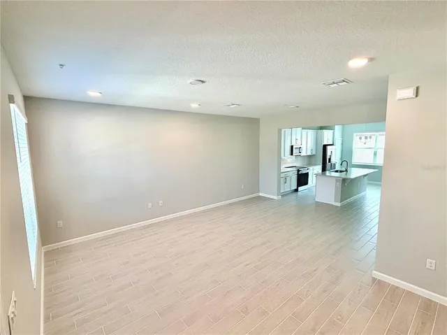 an empty room with a kitchen and a sink