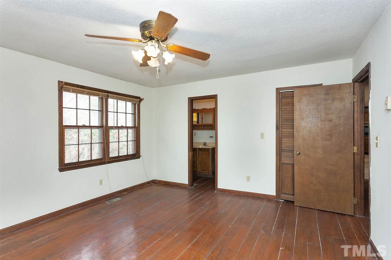 109 Neuse Harbor Drive Raleigh, NC 27610 - Photo 11 of 25 a view of an empty room with wooden floor and a window