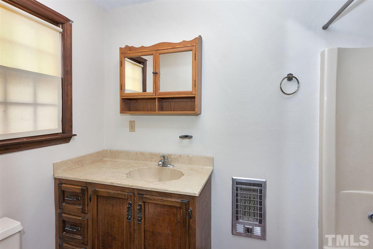 109 Neuse Harbor Drive Raleigh, NC 27610 - Photo 12 of 25 a bathroom with a sink and a mirror