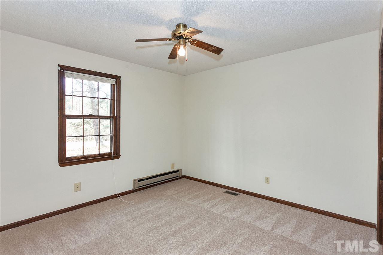 109 Neuse Harbor Drive Raleigh, NC 27610 - Photo 13 of 25 an empty room with chandelier fan and windows
