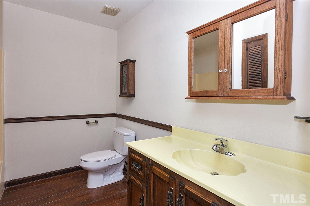 109 Neuse Harbor Drive Raleigh, NC 27610 - Photo 14 of 25 a bathroom with a sink toilet and vanity