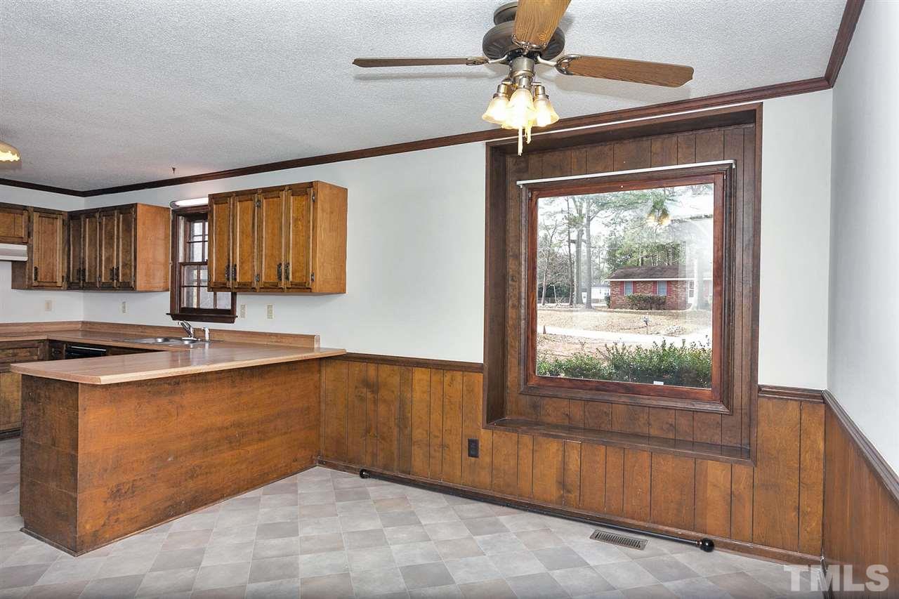 109 Neuse Harbor Drive Raleigh, NC 27610 - Photo 15 of 25 a kitchen with a stove a sink and a refrigerator
