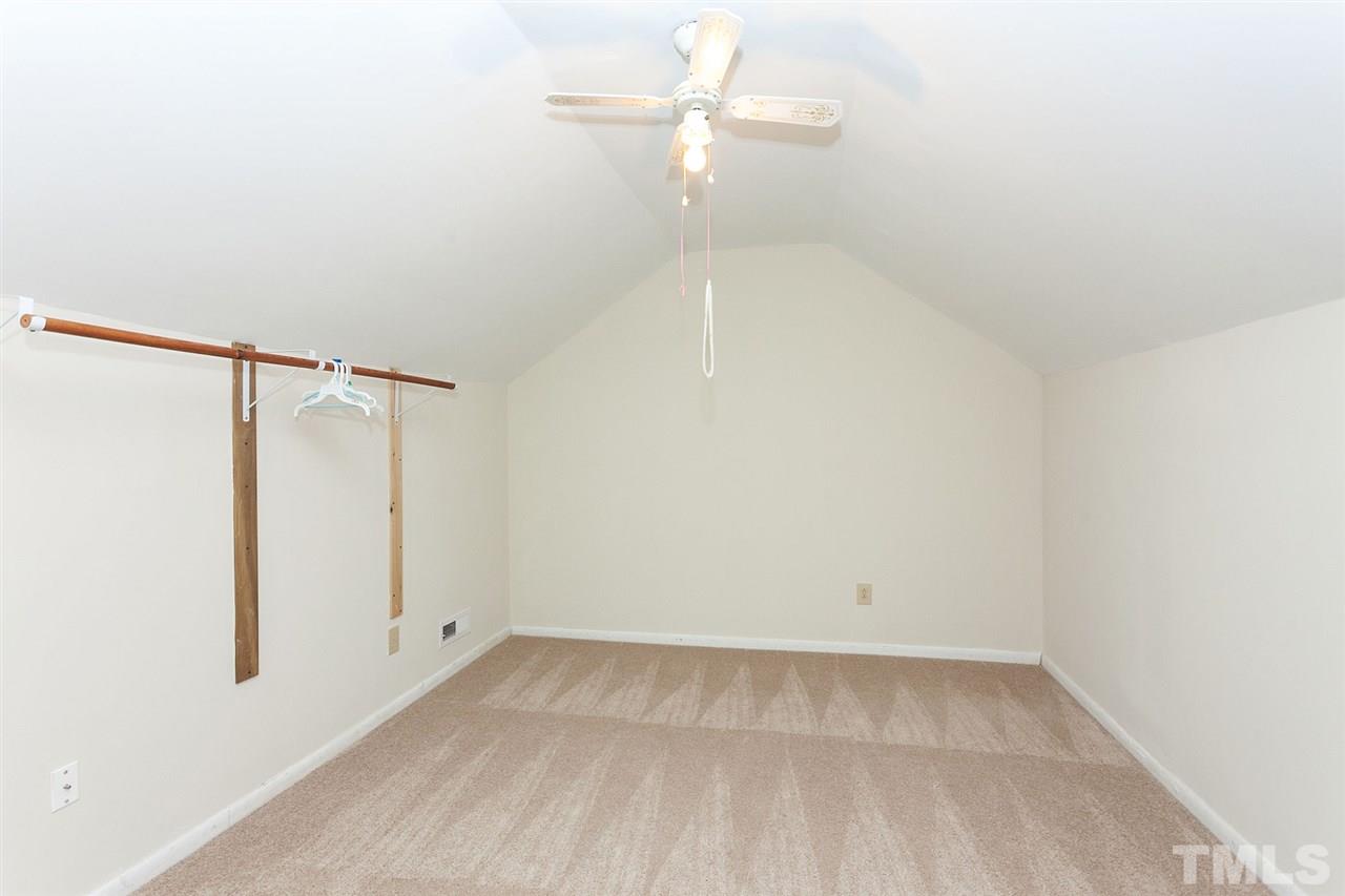109 Neuse Harbor Drive Raleigh, NC 27610 - Photo 19 of 25 an empty room with a ceiling fan and a window