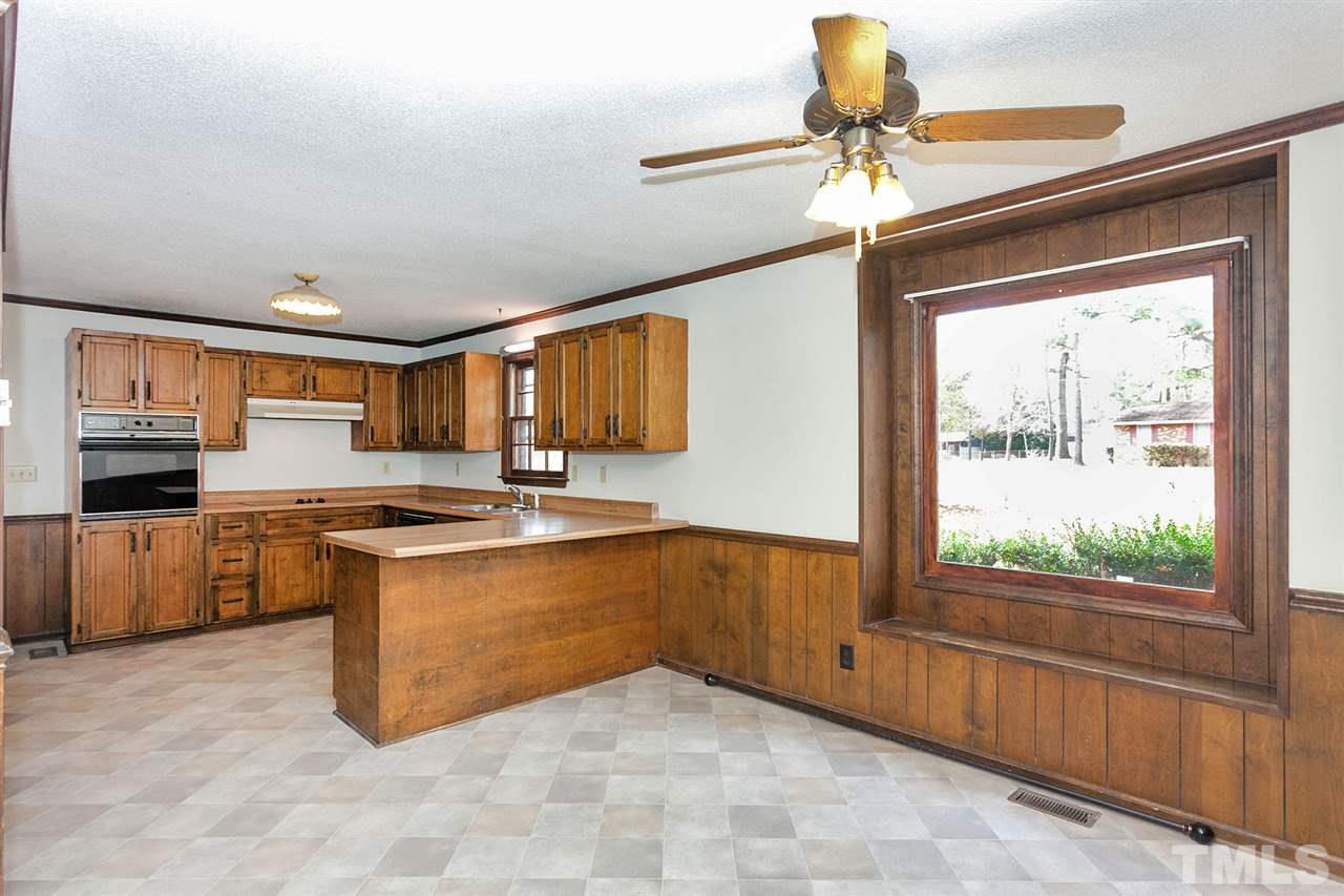 109 Neuse Harbor Drive Raleigh, NC 27610 - Photo 6 of 25 a large kitchen with stainless steel appliances granite countertop a stove a sink and a refrigerator