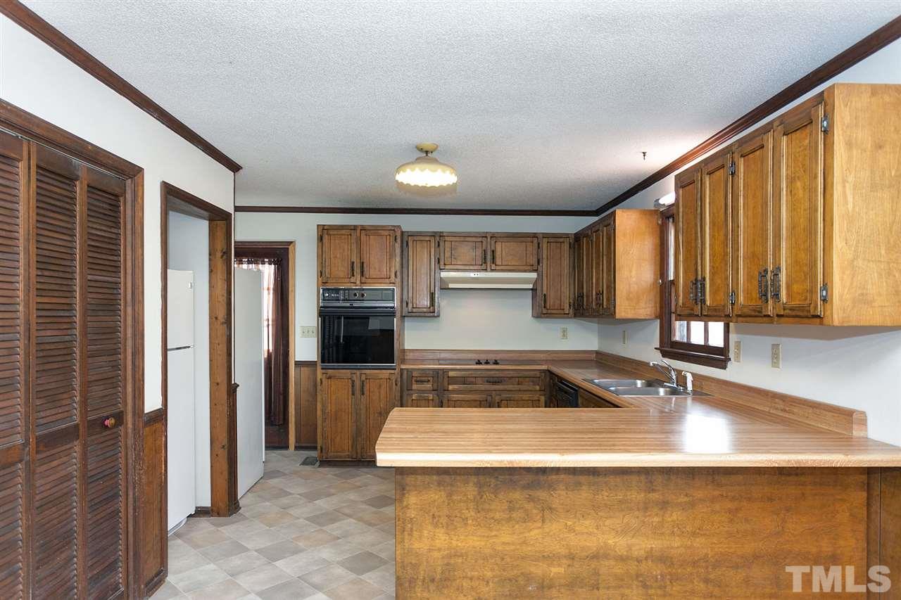 109 Neuse Harbor Drive Raleigh, NC 27610 - Photo 7 of 25 a kitchen with a sink and a refrigerator