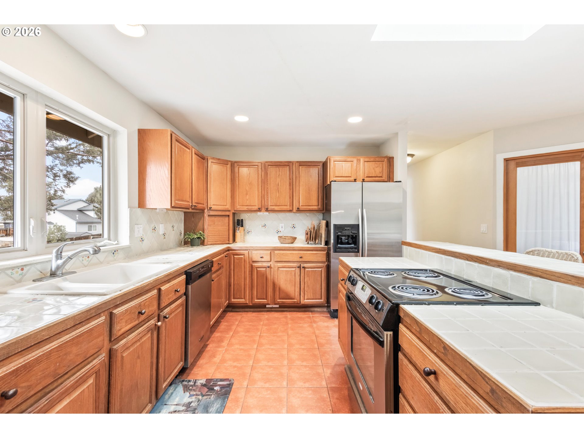 61082 Ferguson Court Bend, OR 97702 - Photo 11 of 48 a kitchen with stainless steel appliances granite countertop a sink stove and refrigerator