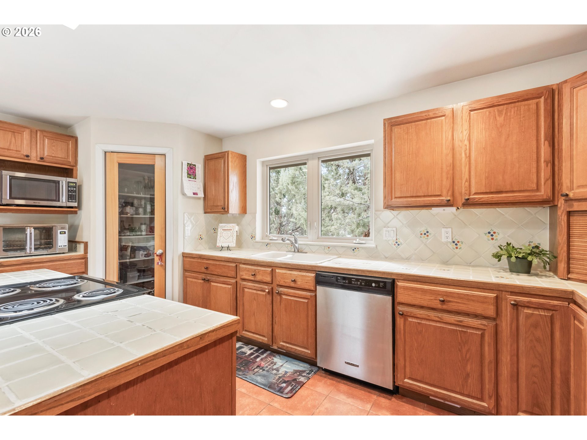61082 Ferguson Court Bend, OR 97702 - Photo 12 of 48 a kitchen with wooden cabinets and sink