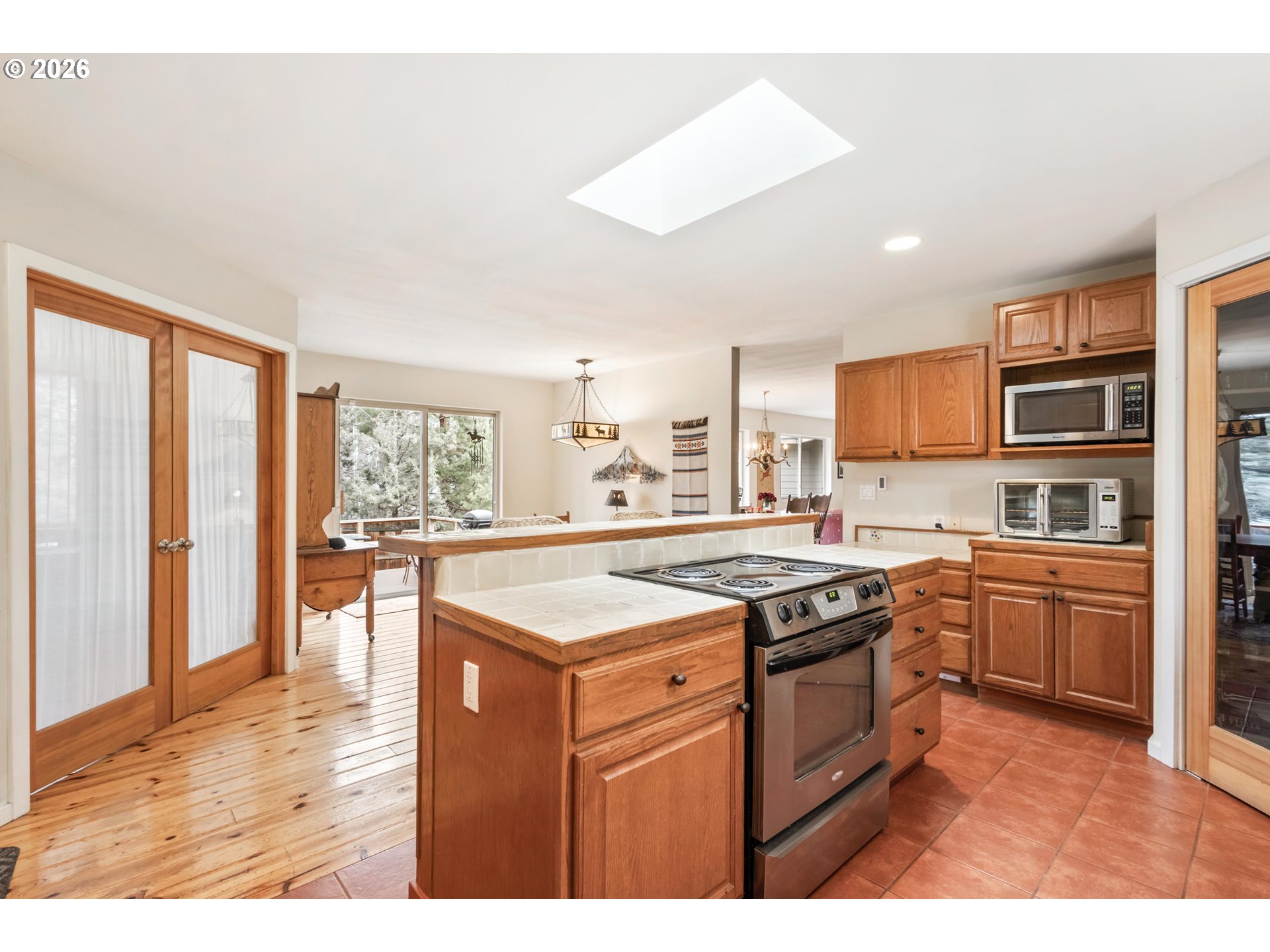 61082 Ferguson Court Bend, OR 97702 - Photo 13 of 48 a kitchen with stainless steel appliances granite countertop a stove a sink dishwasher and a refrigerator