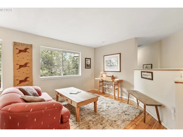 a living room with furniture a table and a large window