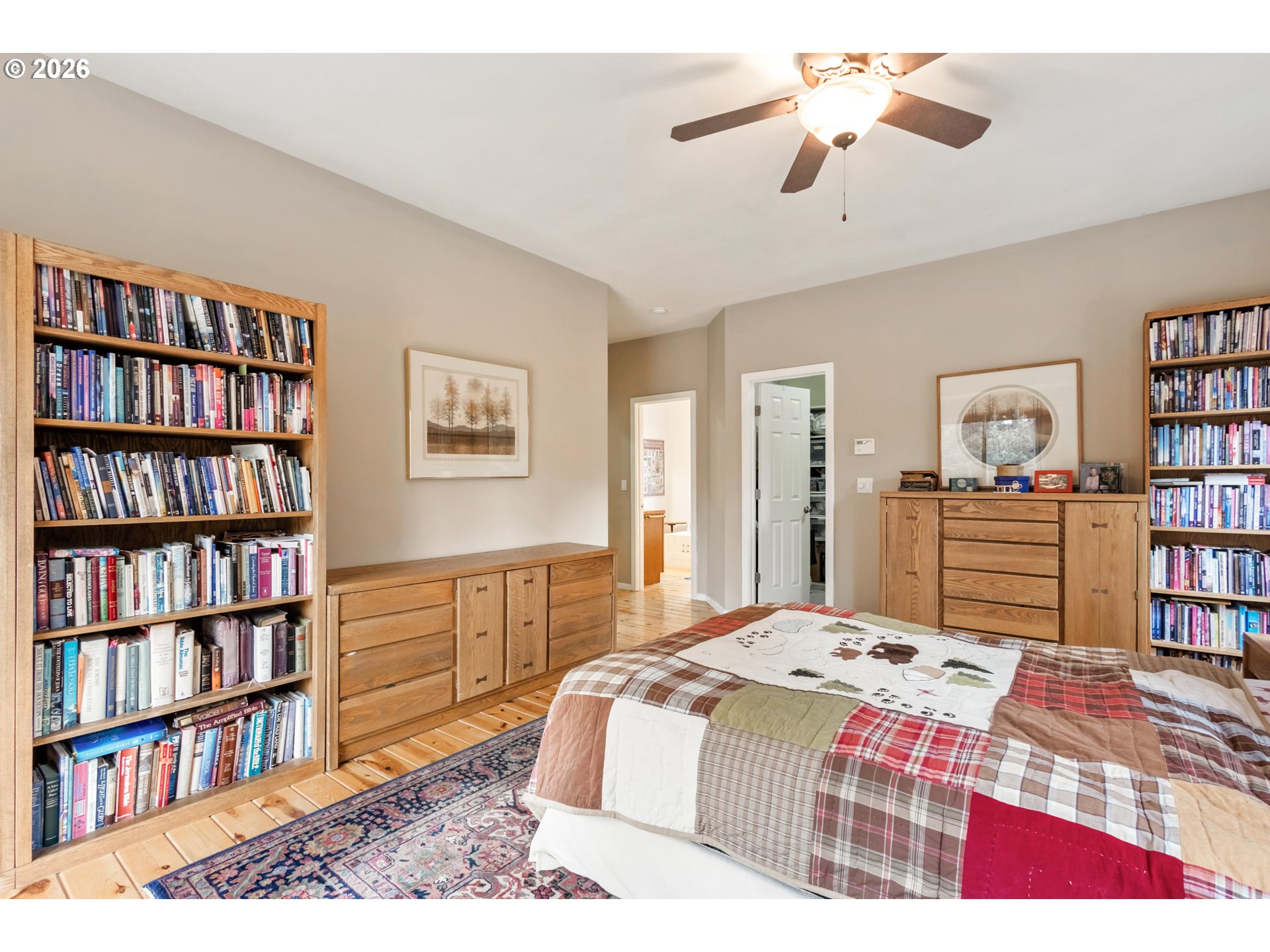 61082 Ferguson Court Bend, OR 97702 - Photo 22 of 48 a bedroom with a bed cabinets and book shelf