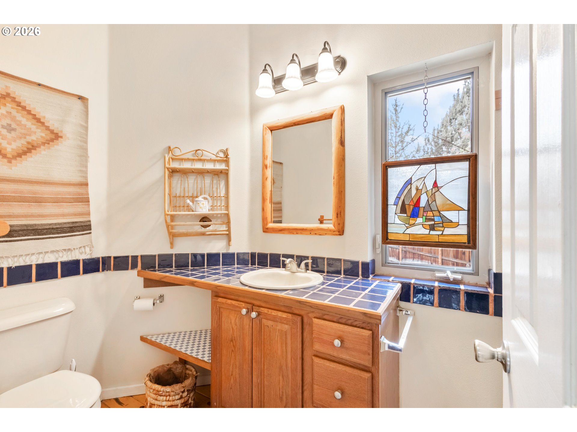61082 Ferguson Court Bend, OR 97702 - Photo 30 of 48 a bathroom with a sinks a large window and a mirror