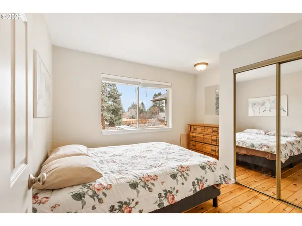 a bedroom with a bed and glass windows