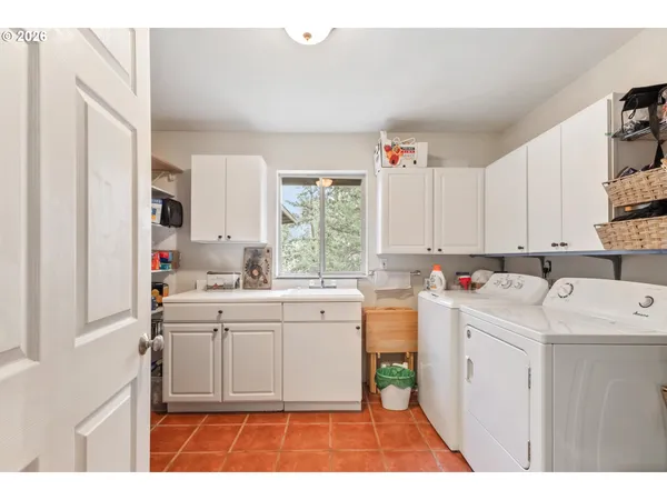 a kitchen that has a sink and a stove in it