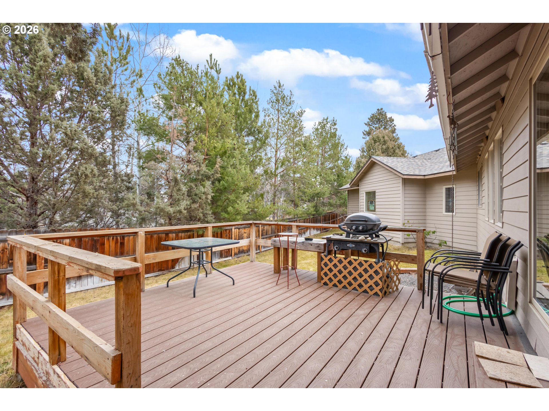 61082 Ferguson Court Bend, OR 97702 - Photo 37 of 48 a balcony with wooden floor table and chairs