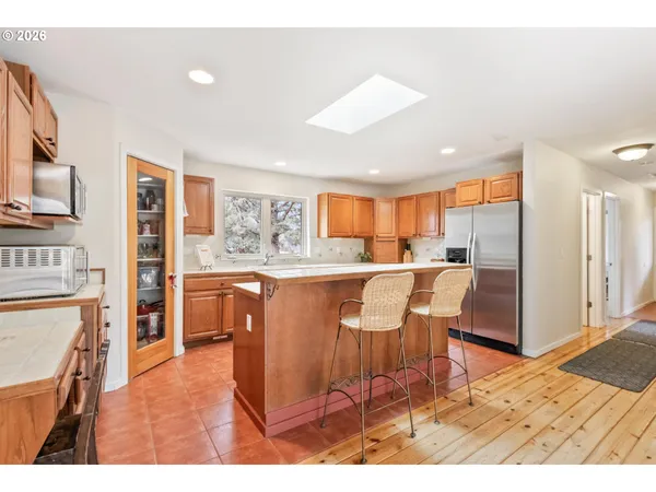 a living room with stainless steel appliances kitchen island granite countertop furniture and a kitchen view